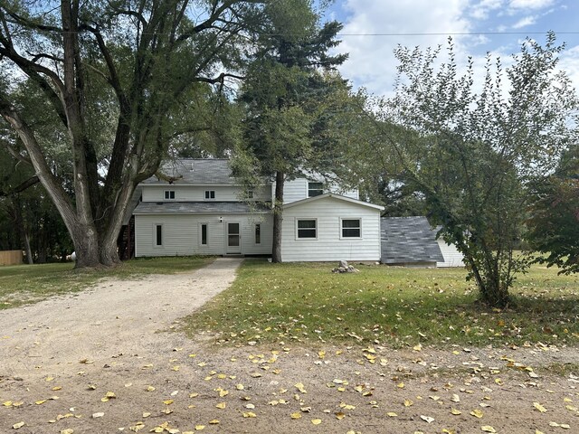 13664 Wabasis Ave NE, Cedar Springs, MI 49319 - back of house with dirt driveway and a lawn