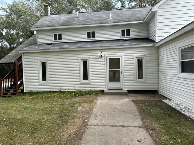 13664 Wabasis Ave NE, Cedar Springs, MI 49319 - view of front of property featuring a chimney, stairway, a front yard, and roof with shingles