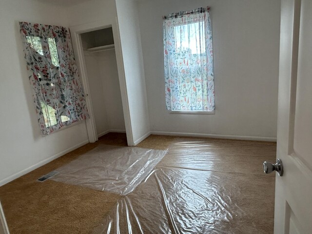 13664 Wabasis Ave NE, Cedar Springs, MI 49319 - unfurnished bedroom with carpet floors, baseboards, and a closet