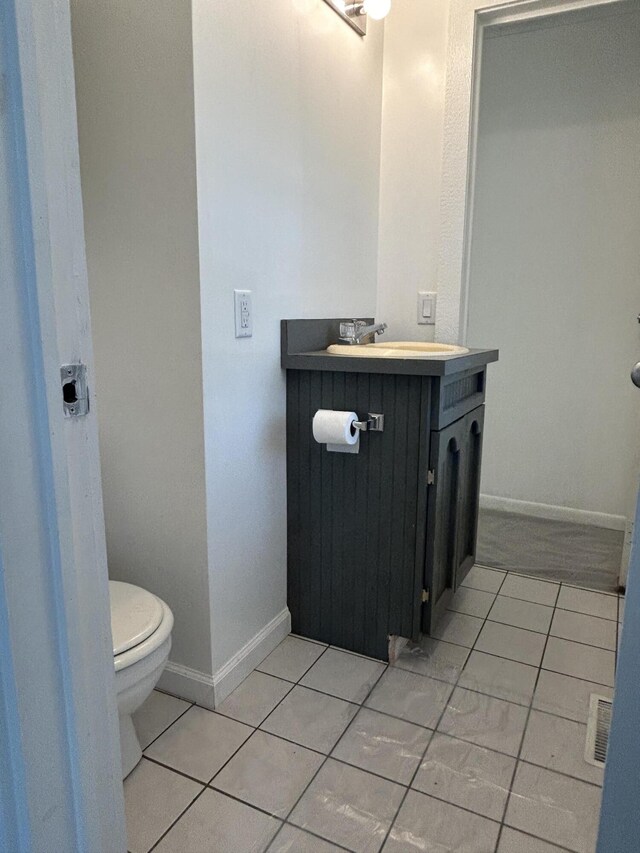 13664 Wabasis Ave NE, Cedar Springs, MI 49319 - half bath with toilet, vanity, tile patterned floors, and baseboards