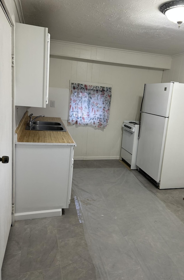 13664 Wabasis Ave NE, Cedar Springs, MI 49319 - kitchen with white appliances, a sink, light countertops, white cabinets, and a textured ceiling