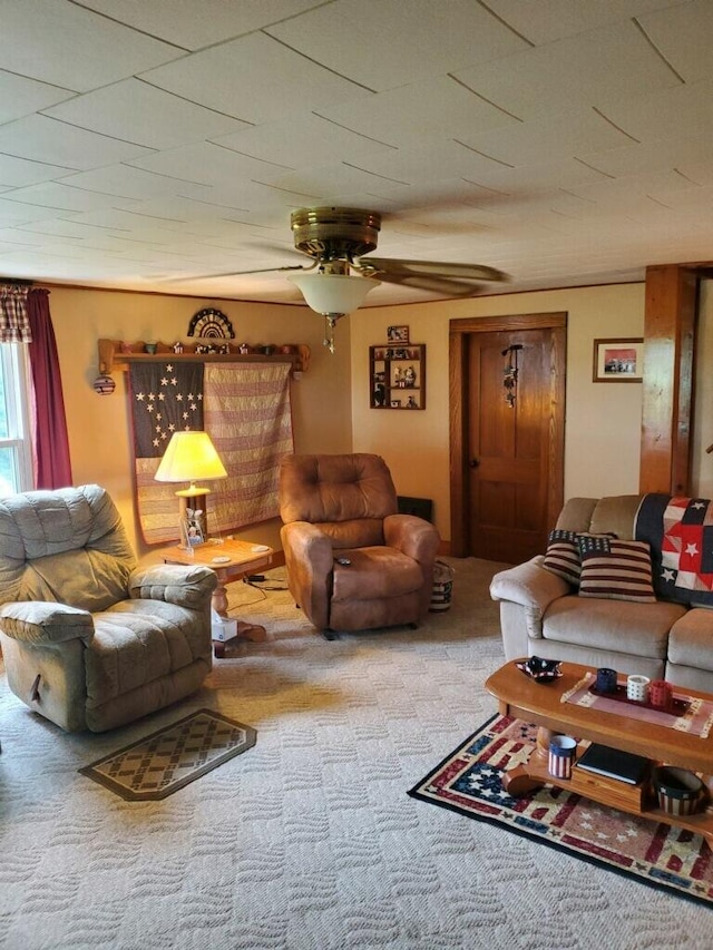 carpeted living room with ceiling fan