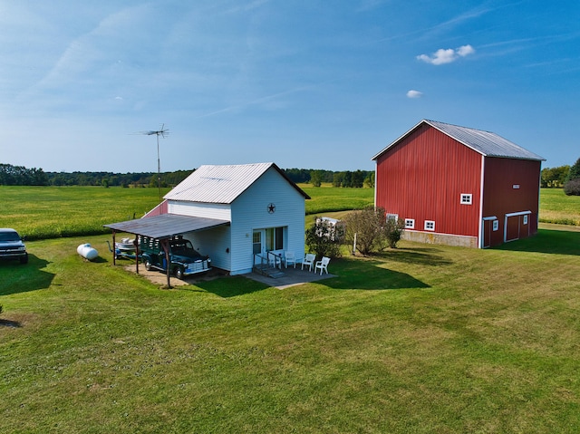 rear view of property with a lawn and a carport