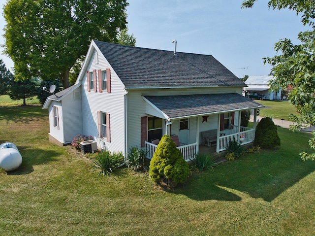 view of property exterior with a lawn, central AC unit, and a porch