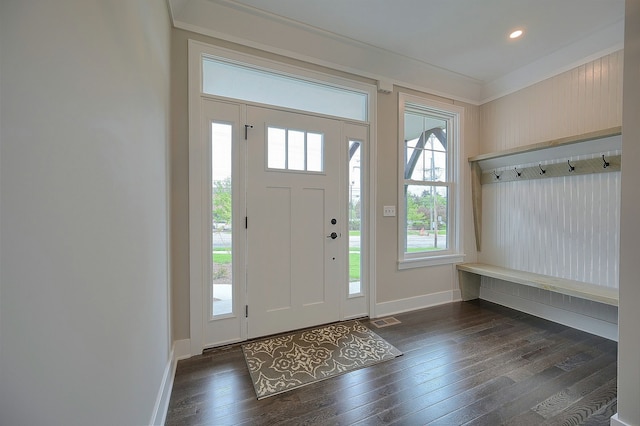 entryway featuring ornamental molding and dark wood-type flooring