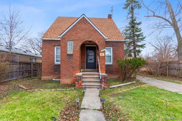 bungalow-style home with a front lawn