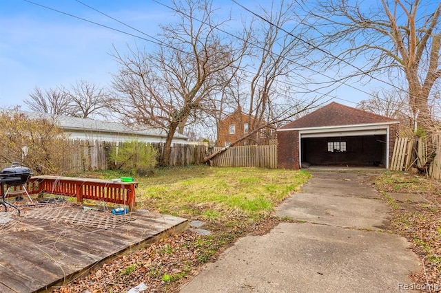 view of yard with a garage and an outbuilding