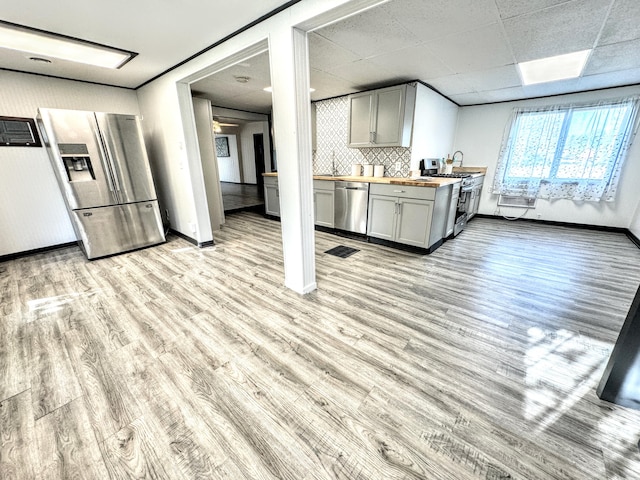 kitchen with wooden counters, appliances with stainless steel finishes, and light wood-type flooring