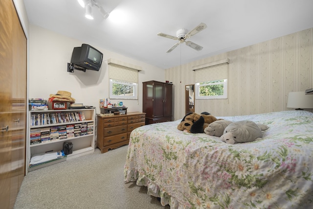 bedroom with light carpet and ceiling fan