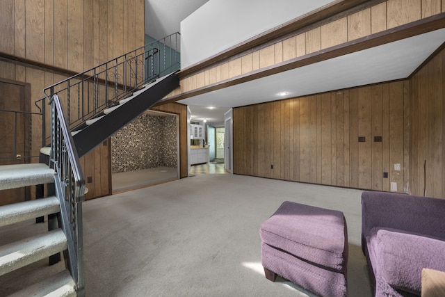 interior space featuring wooden walls and carpet floors