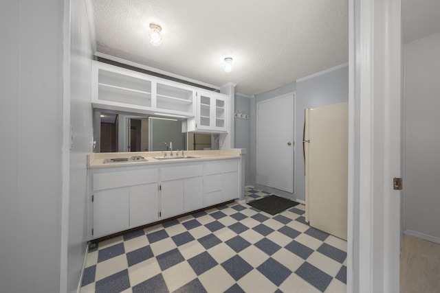 bathroom featuring crown molding, vanity, and a textured ceiling