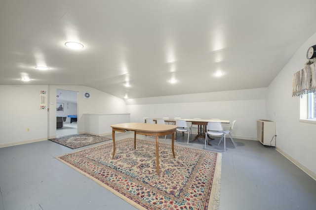 game room with concrete floors and vaulted ceiling