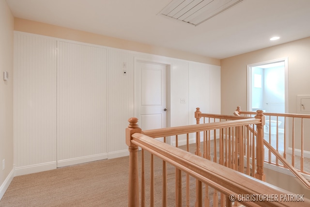 hall featuring recessed lighting, baseboards, light colored carpet, and an upstairs landing