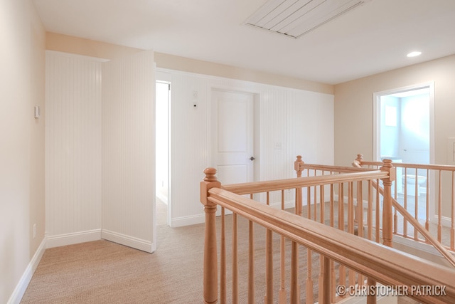 corridor featuring light carpet, recessed lighting, an upstairs landing, and baseboards