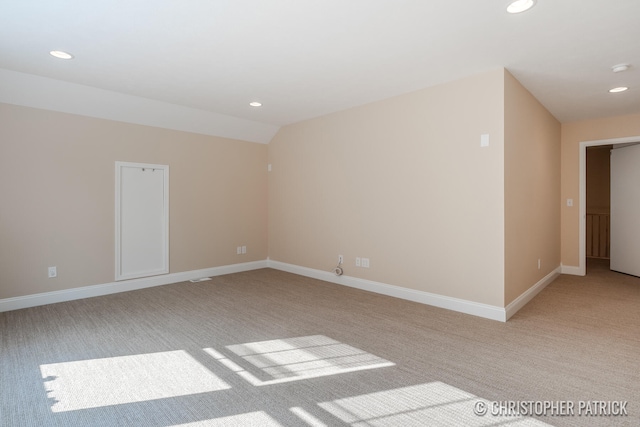 unfurnished room featuring light colored carpet, baseboards, vaulted ceiling, and recessed lighting