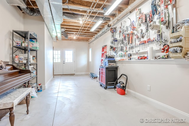 basement featuring a workshop area and baseboards