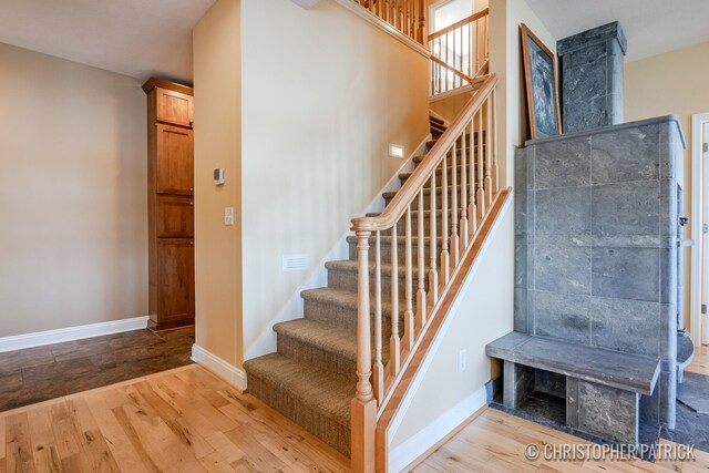 stairs with baseboards and wood finished floors