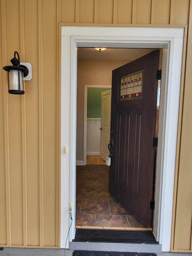 property entrance featuring board and batten siding