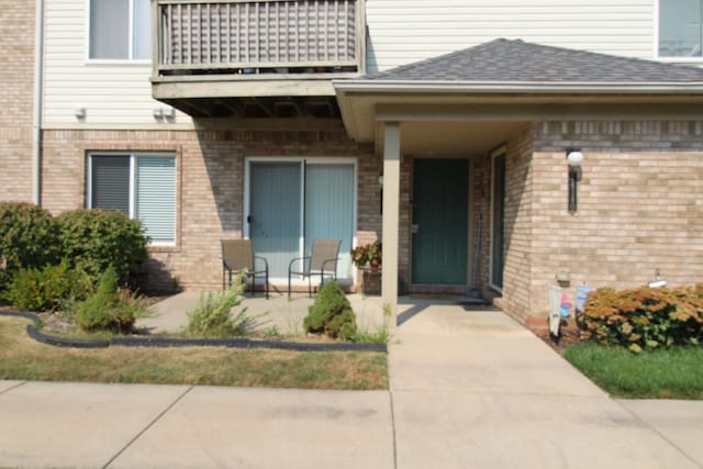 entrance to property with a patio area and a balcony