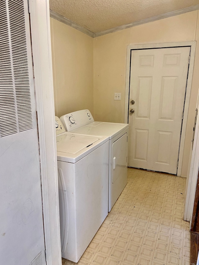 laundry room featuring separate washer and dryer and a textured ceiling