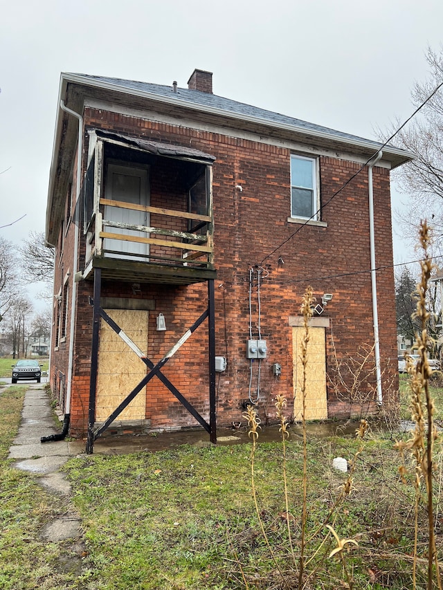 back of property featuring a balcony