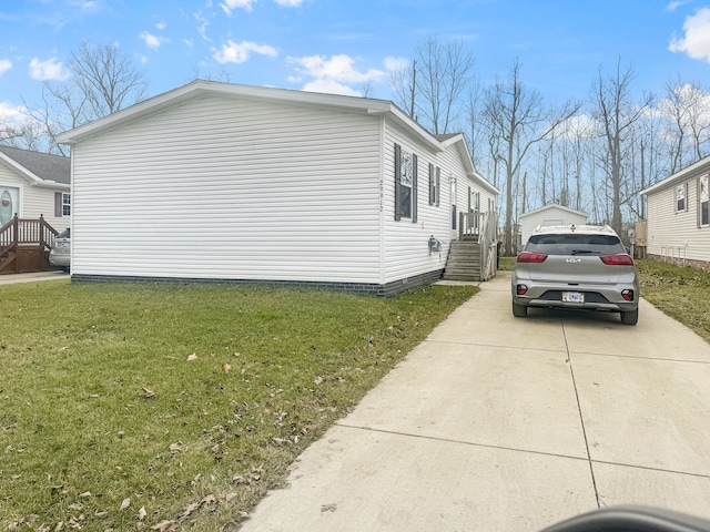 view of side of home with a yard