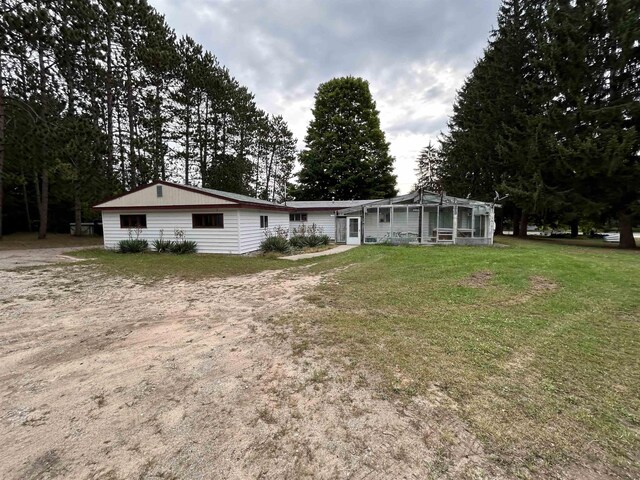 2768 S M-88, Bellaire, MI 49615 - rear view of property featuring a lawn