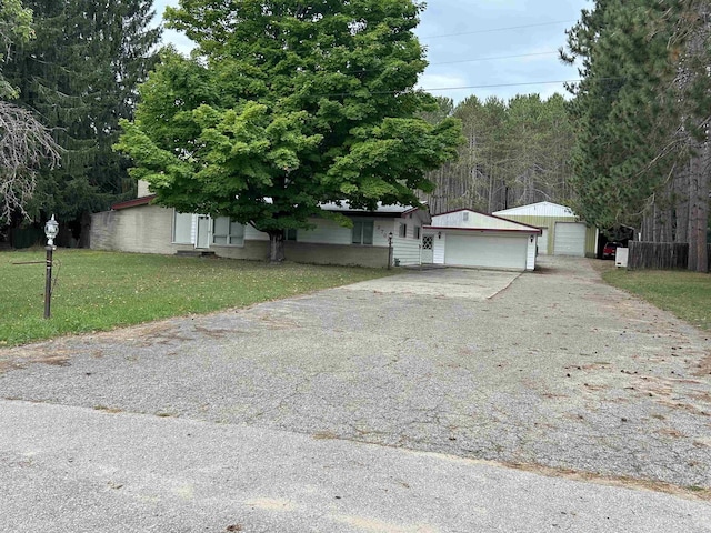 2768 S M-88, Bellaire, MI 49615 - view of front facade featuring a garage and a front yard
