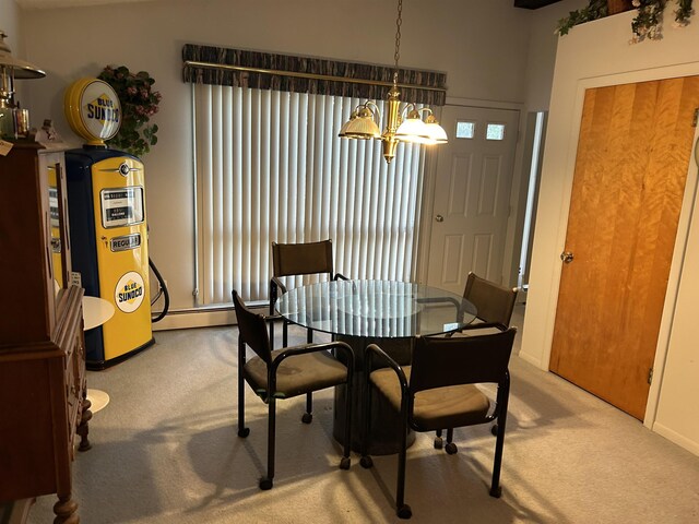 2768 S M-88, Bellaire, MI 49615 - dining room featuring light colored carpet, a baseboard radiator, and a notable chandelier