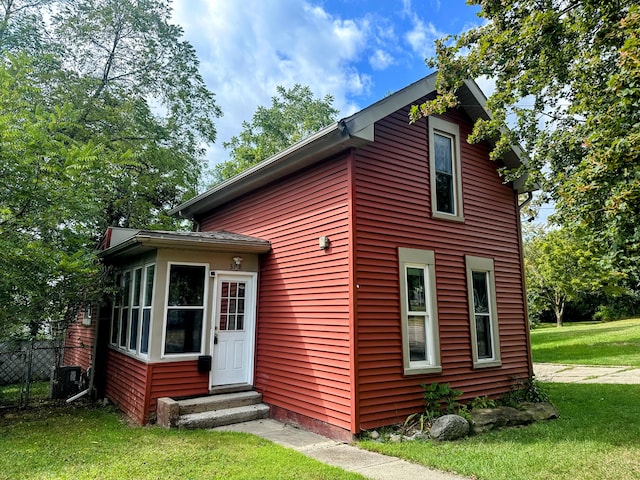 rear view of house with a yard