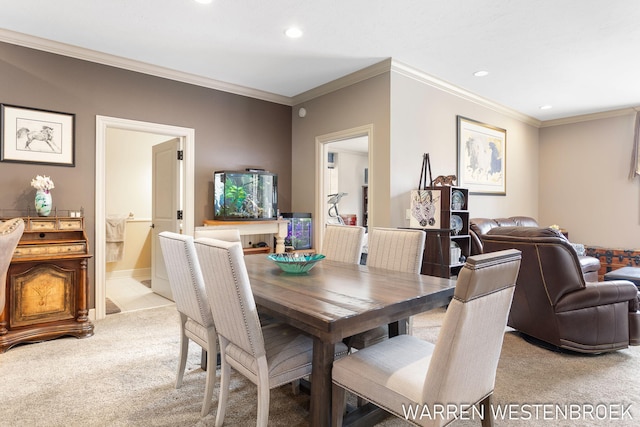 dining space with light carpet and ornamental molding