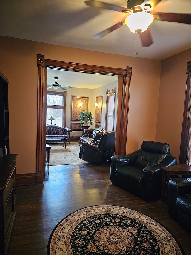 living room with wood-type flooring and ceiling fan