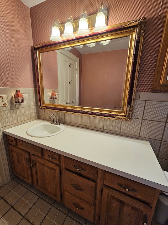 bathroom featuring tile patterned flooring, vanity, and tile walls