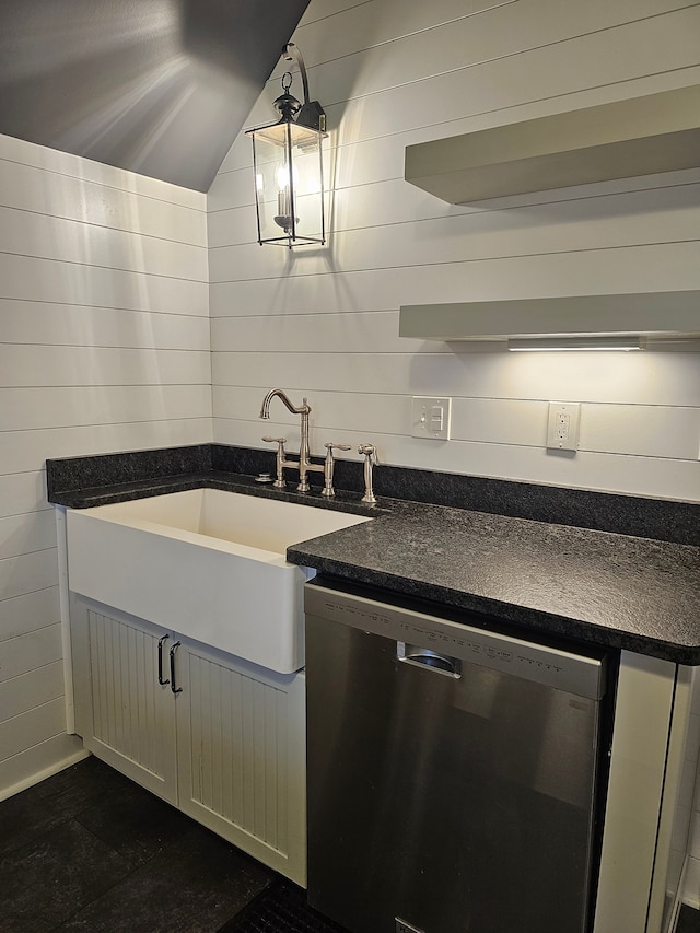 kitchen featuring dishwasher, sink, pendant lighting, vaulted ceiling, and white cabinets