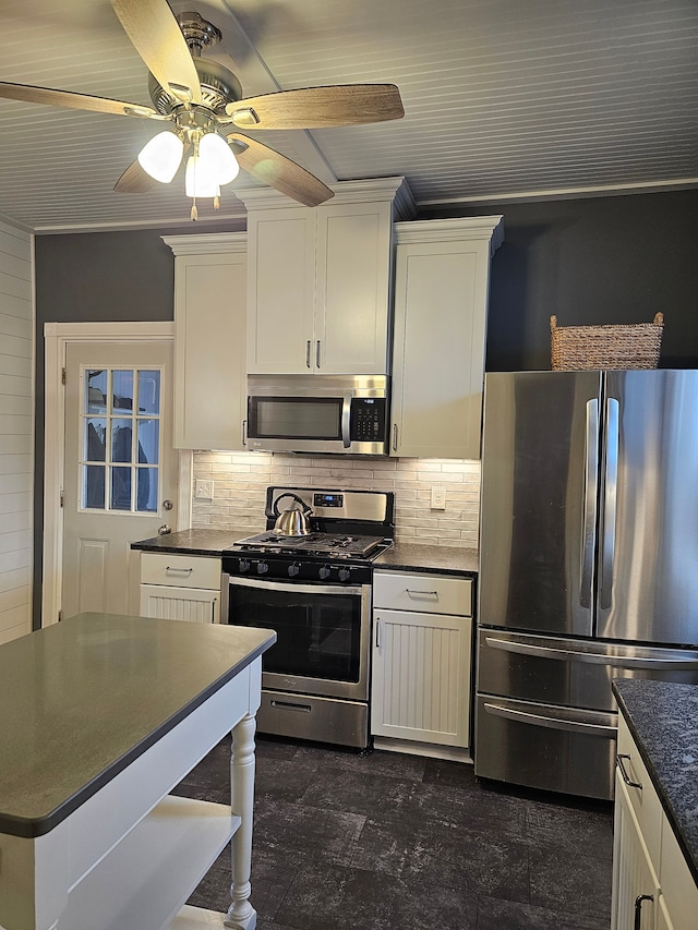 kitchen with decorative backsplash, white cabinets, stainless steel appliances, and ornamental molding