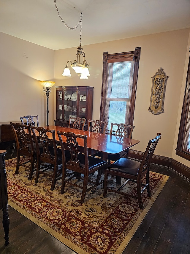 dining room featuring hardwood / wood-style floors and an inviting chandelier