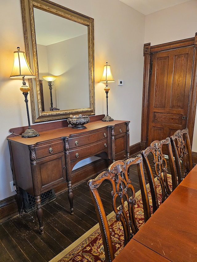 home office with dark wood-type flooring