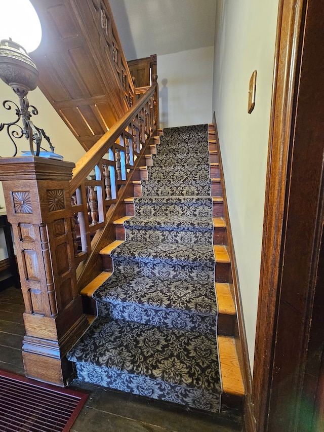 stairs featuring hardwood / wood-style floors