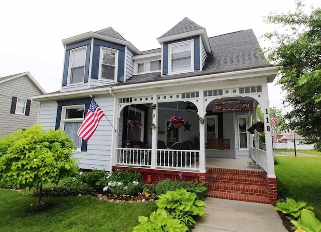 view of front of house with covered porch and a front yard