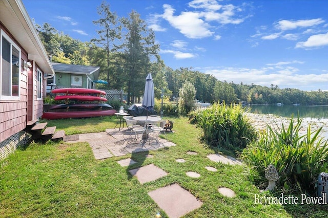 748 Kimberly Dr NE, Sparta, MI 49345 - view of yard featuring a water view and a patio area