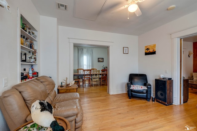 living room with ceiling fan and light hardwood / wood-style floors