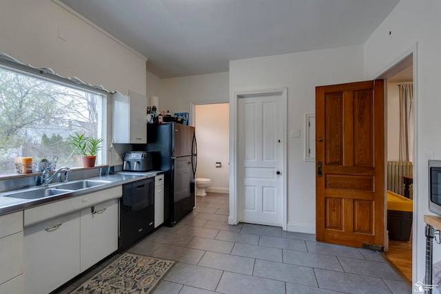 kitchen with white cabinets, light tile patterned floors, black appliances, and sink