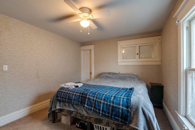 bedroom featuring multiple windows and ceiling fan