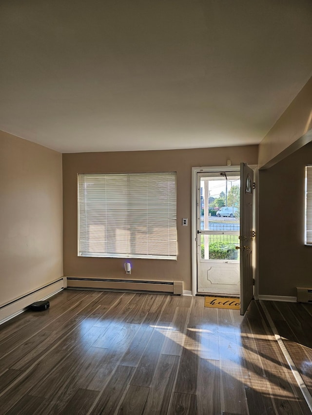 entrance foyer with dark hardwood / wood-style floors and baseboard heating