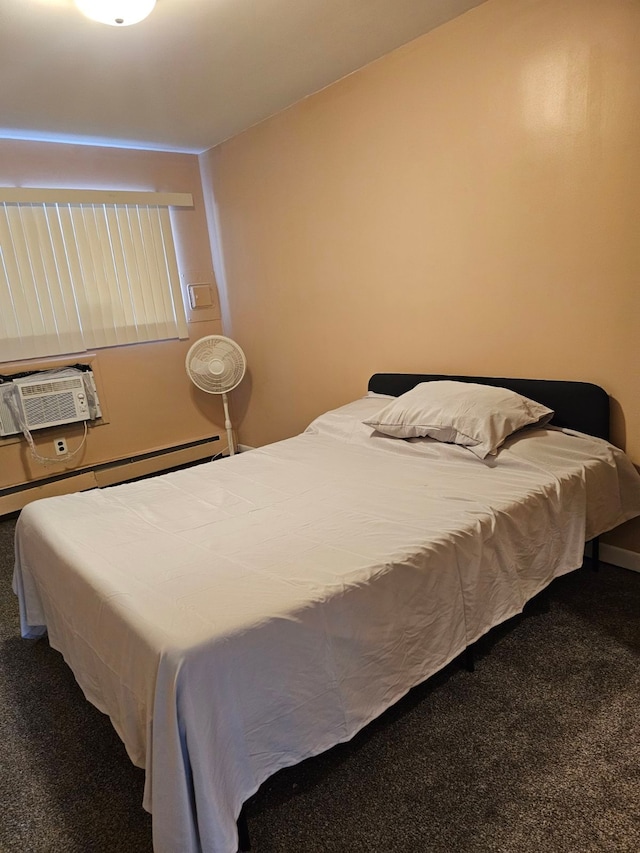 bedroom featuring carpet floors, a wall unit AC, and a baseboard heating unit