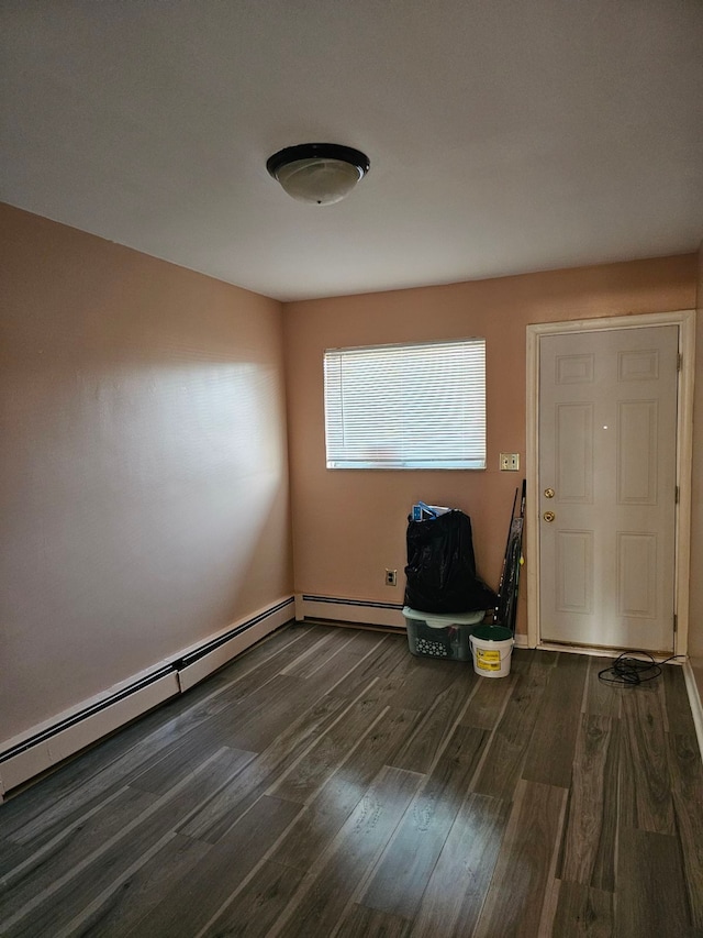 foyer entrance featuring dark hardwood / wood-style floors and a baseboard heating unit