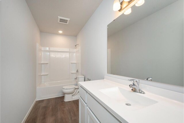 full bathroom with wood-type flooring, toilet, shower / bathing tub combination, and vanity