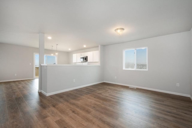 empty room featuring dark hardwood / wood-style flooring