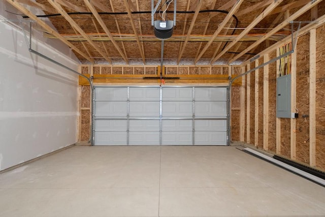 garage with a garage door opener and electric panel