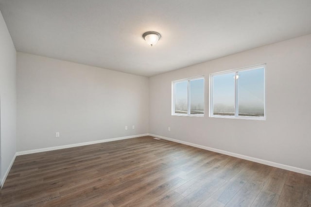 spare room with dark hardwood / wood-style floors